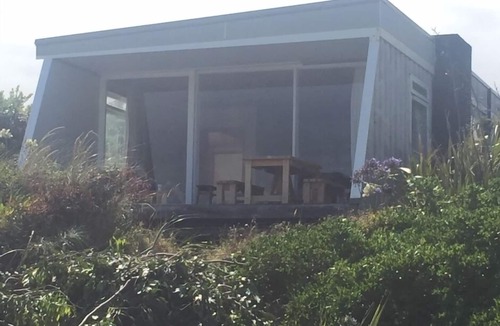 Waikanae House | Iconic absolute beachfront 60s bach