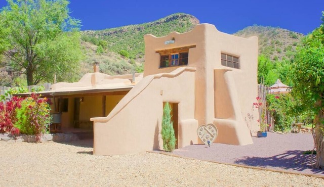 A romantic adobe, river retreat with outdoor tubs.