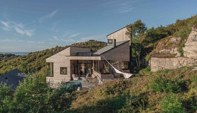 Architect drawn cabin between sea and mountain
