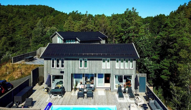 Beach villa with pool and boat dock near Trysnes